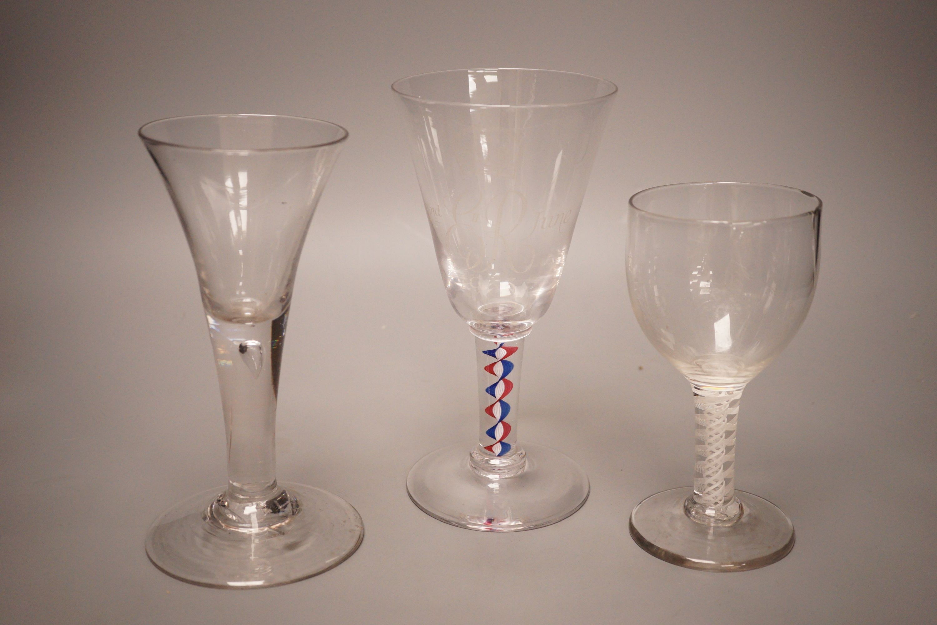A mid 18th century drawn trumpet ale glass with air tear, a George III d.s.o.t. wine glass (a.f.) and a Whitefriars 1953 coronation colour twist wine glass